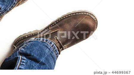 Men's brown boots and blue jeans isolated 44699367