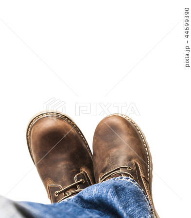 Men's brown boots and blue jeans isolated 44699390