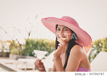 Swimsuit Concept. Beautiful girls in swimwear are drinking. Asia Swimsuit Concept. Beautiful girls in swimwear are drinking. Asia 44700787