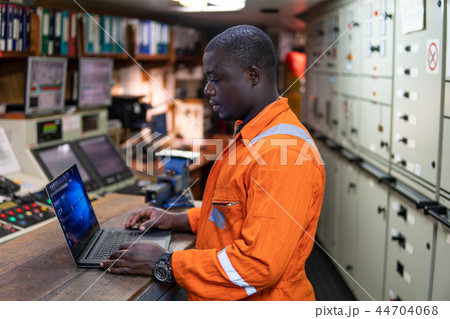 Marine engineer officer working in engine room 44704068