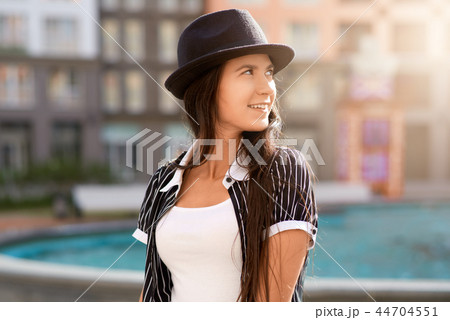 Positive long-haired brunette girl in a hat Positive long-haired brunette girl in a hat 44704551