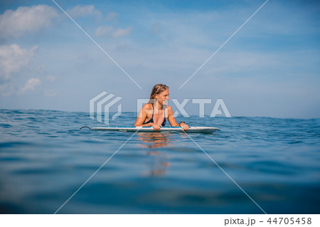 Beautiful surfgirl relaxed with surfboard Beautiful surfgirl relaxed with surfboard 44705458