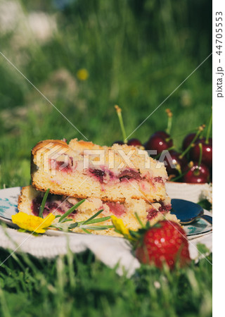 Few portions of cherry cake on white plate  44705553