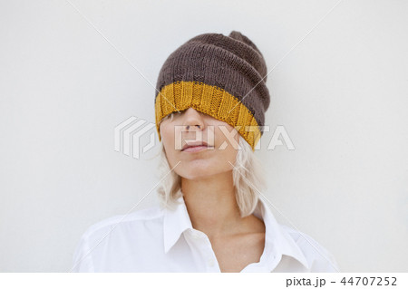 Beautiful woman in warm brown beanie hat. Beautiful woman in warm brown beanie hat. 44707252