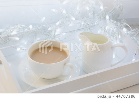 Cup of black coffee on winter windowsill. Xmas. 44707386