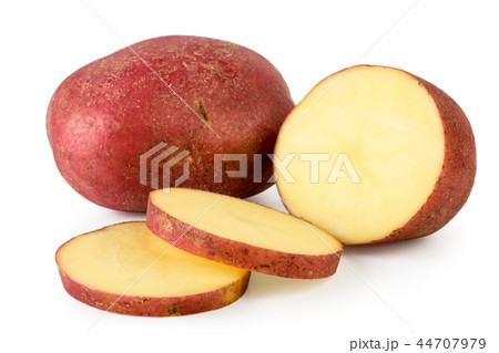 Red potatoes and half cut into pieces on a white Red potatoes and half cut into pieces on a white 44707979