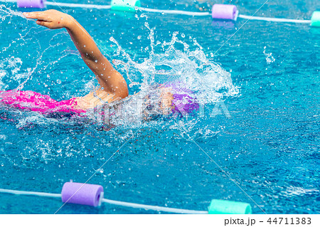 Young girl swimmer working on her freestyle swim Young girl swimmer working on her freestyle swim 44711383