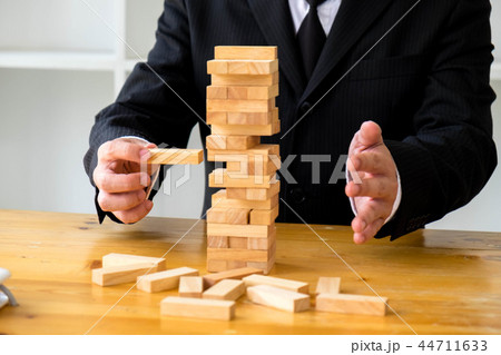 Businessmen picking domino to fill the missing. 44711633