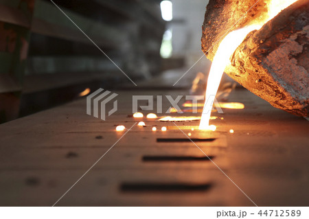 Iron molten metal pouring in sand mold Iron molten metal pouring in sand mold 44712589
