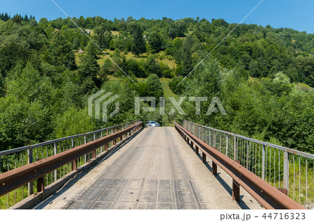 Old car bridge with rusty railing against the back Old car bridge with rusty railing against the back 44716323