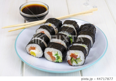 Rolls with salmon, plate on wooden table Rolls with salmon, plate on wooden table 44717877