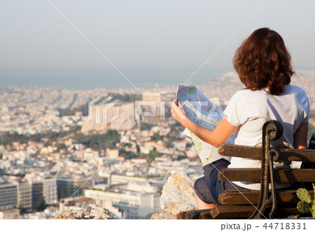 woman with a map sitting on Lycabettus Hill woman with a map sitting on Lycabettus Hill 44718331