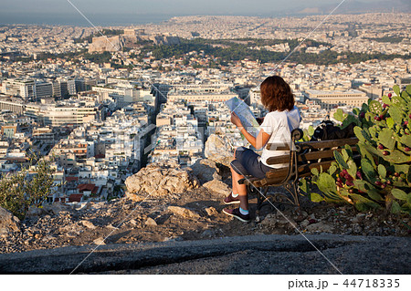 woman with a map sitting on Lycabettus Hill woman with a map sitting on Lycabettus Hill 44718335