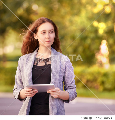 Girl with laptop. Outdoors. Young student. Office  44718853