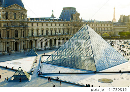 Glass pyramid and people walking in Louvre, Paris, France. 44720316