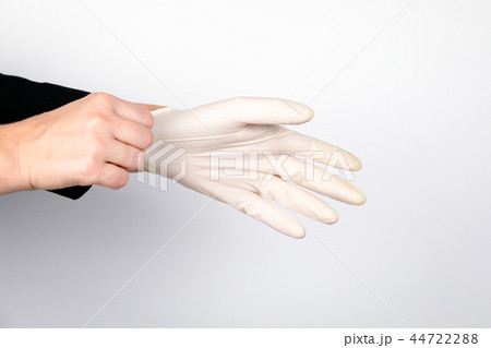 woman doctor wears medical gloves woman doctor wears medical gloves 44722288