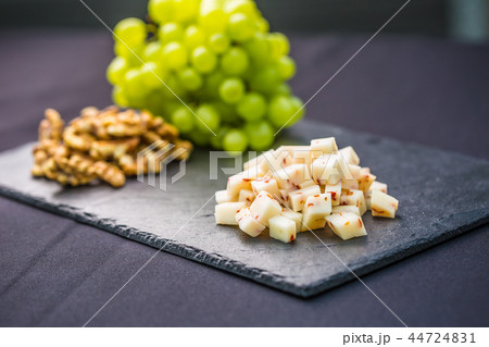 Cheese pieces juicy grapes and walnuts. 44724831