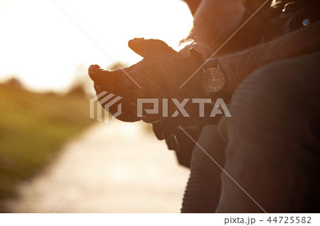 Putting on the gloves to drive a bike Putting on the gloves to drive a bike 44725582