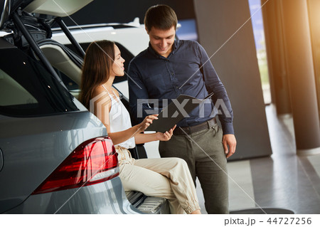 Loving smart couple choosing a car at the car dealership showroom 44727256