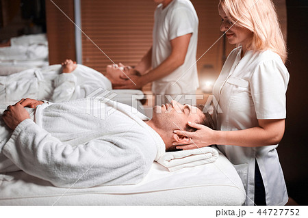 Man receiving back massage from masseur in spa Man receiving back massage from masseur in spa 44727752