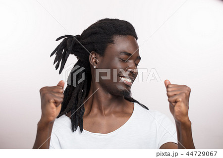 handsome happy young african man with dreadlocks on white background 44729067