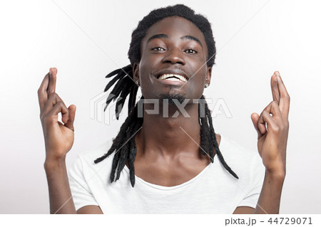 African American male crosses fingers, Dark skinned man wishes dreams 44729071