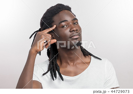 young executive african man gesturing with finger against temple young executive african man gesturing with finger against temple 44729073
