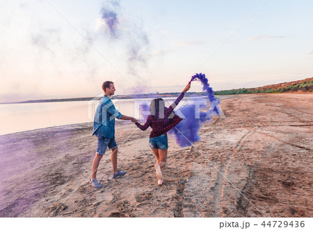 young couple running with hand flare or fusee 44729436