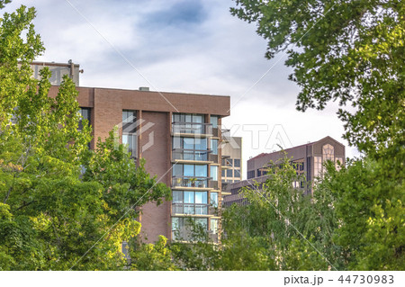 Residential high rise with puffy clouds Residential high rise with puffy clouds 44730983