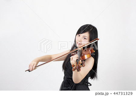 Brunette Woman Wearing a Yellow Sweater, and Playing Violin by