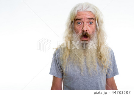 Studio shot of senior bearded man looking shocked Studio shot of senior bearded man looking shocked 44733507