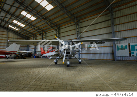 outdoor shot of small plane standing in shed outdoor shot of small plane standing in shed 44734514