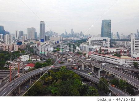 Cars driving on bridge roads shaped curve highways with skyscrap 44735782
