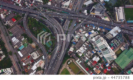 Cars driving on bridge roads shaped curve highways with skyscrap 44735788