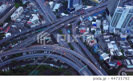 Cars driving on bridge roads shaped curve highways with skyscrap Cars driving on bridge roads shaped curve highways with skyscrap 44735792