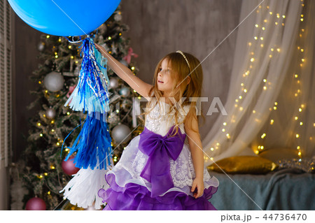 Little girl celebrates Christmas at home Little girl celebrates Christmas at home 44736470