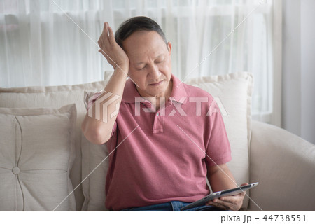 Asian old man at home having a headache Asian old man at home having a headache 44738551