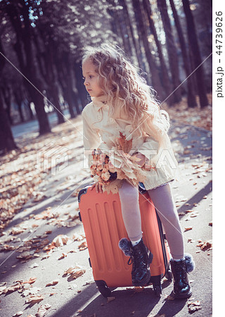 Little girl with blond hair in autumn background 44739626