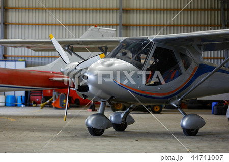 outdoor shot of small plane standing in shed outdoor shot of small plane standing in shed 44741007
