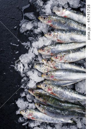 Raw sardine on ice offered Raw sardine on ice offered 44745716