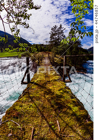 Suspension bridge over the mountain river, Norway. 44746857
