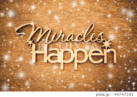 Inscription miracles happen on a wooden background Inscription miracles happen on a wooden background 44747193