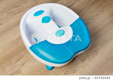 Feet in a vibrating foot massager.massage bath.  44748488