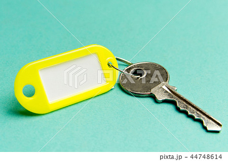 Yellow key tag on a turquoise Yellow key tag on a turquoise 44748614