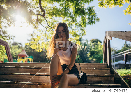 Young woman wearing shorts and white top 44749432