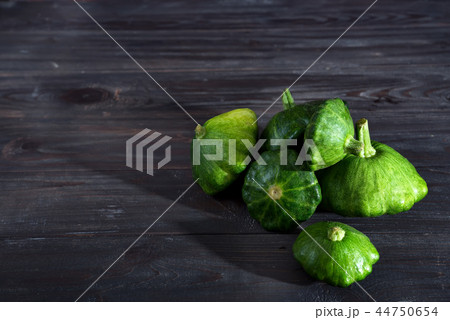 small size patty pan patisson squash on dark wooden background with copy space small size patty pan patisson squash on dark wooden background with copy space 44750654