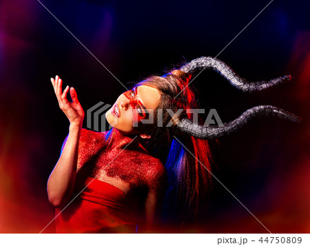 Halloween monster woman with horns and fire flame. 44750809