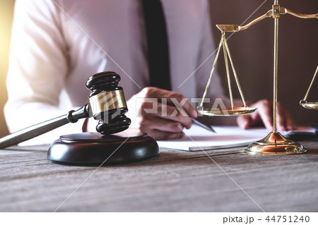 Male lawyer or judge working with Law books, gavel and balance, 44751240