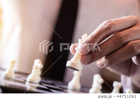 Hand of confident businessman use king chess piece white playing 44751261