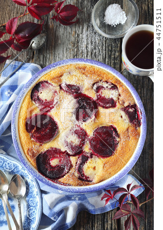 Autumn dessert. Red plums clafoutis and coffee 44751511